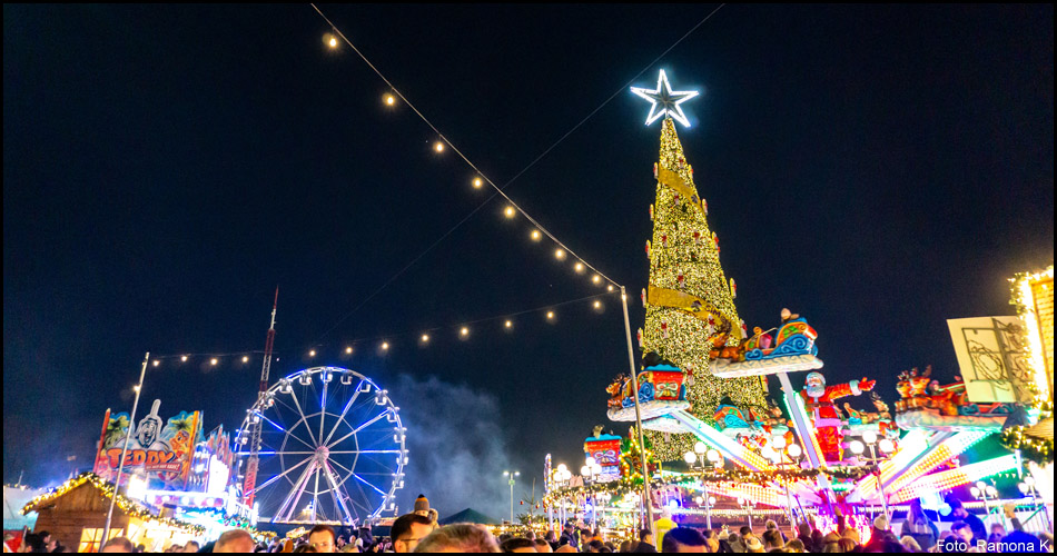 Bild des nächtlichen Cranger Weihnachtszauber mit Weihnachtsmarkt, Kirmesbuden, Riesenrad und Weihnachtsbaum