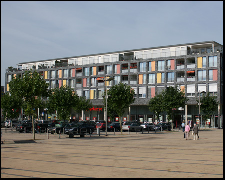 Einkaufszentrum und Wohnhaus vor der Akademie