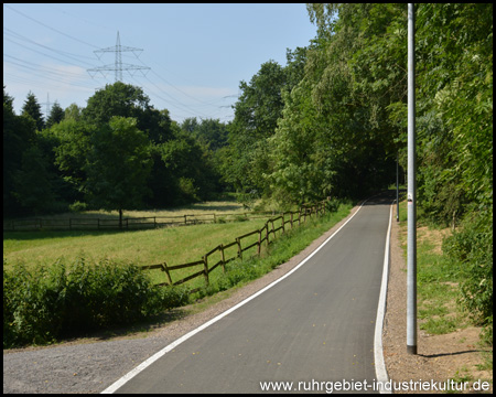 Ländlich gelegener und beleuchteter Trassenweg (Blick zurück)