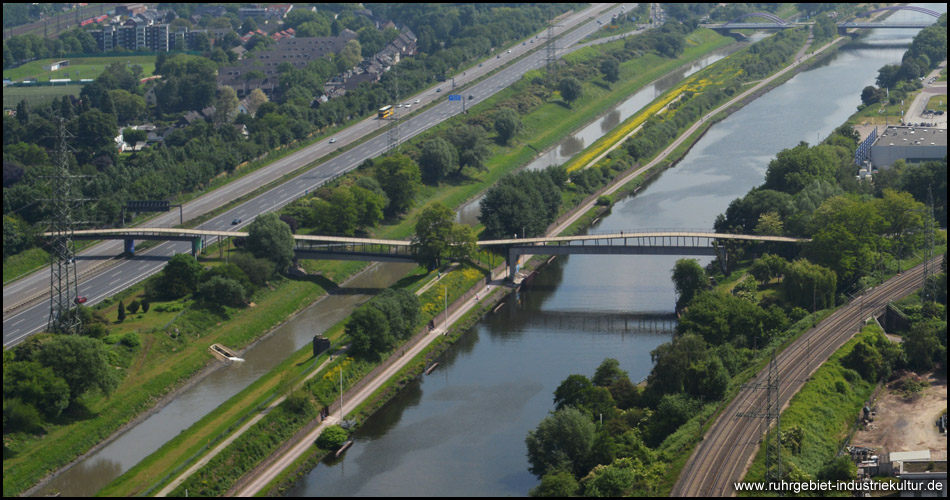 Die Tausendfüßlerbrücke über Kanal, Emscher und Autobahn vom Gasometer gesehen. Deutlich erkennbar ist die schmale "Emscherinsel" zwischen den Gewässern und der Radweg. Auf unserer Tour kommen wir von rechts oben und fahren in die linke untere Ecke.
