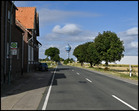 Straße mit Häusern und einem blauen Wasserturm